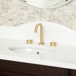 Deck mounted 3 hole decca basin mixer in gold with rounded spout.