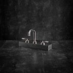 Landmark industrial chrome tap with round spout on a dark block.