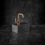 Landmark industrial brass mono tap on a dark block.