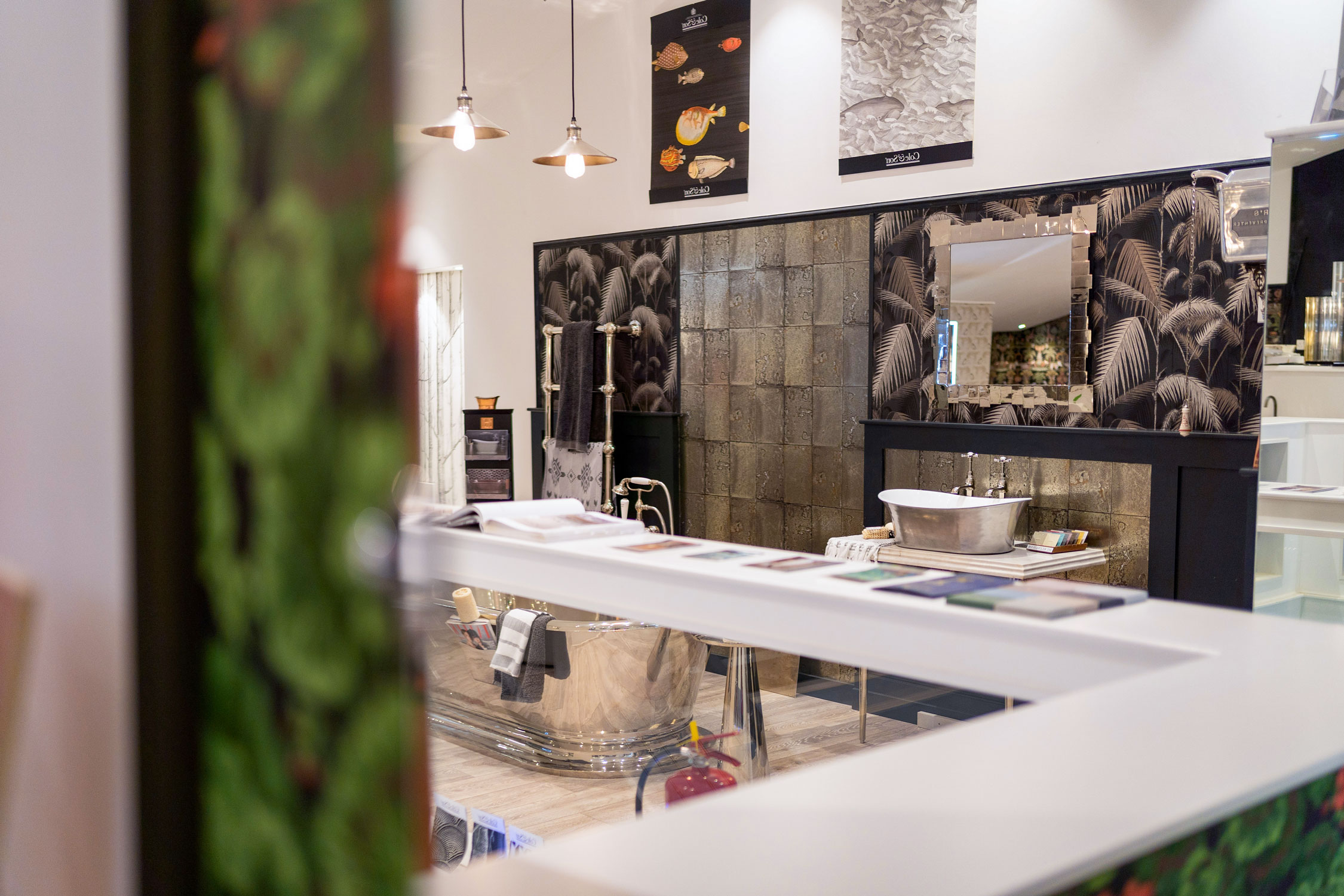 Artistic view of harlequin bathrooms showroom with cast iron basin in background.