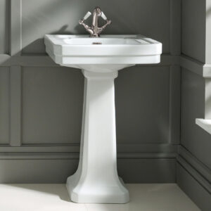 Victrion 540 basin with pedestal in corner of room with grey walls.
